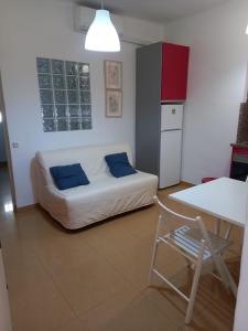 een kamer met een bank, een tafel en een keuken bij Riverside Triana in Sevilla