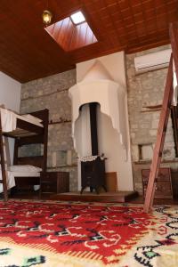 a room with a fireplace and a rug on the floor at Villa Athina in Berat Castle - Since 1741 in Berat