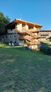 una casa con una terraza a un lado en BeB LUCA76 en Avise