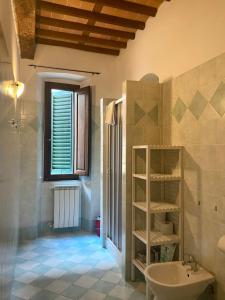 a bathroom with a sink and a toilet in a room at Casa Toscanella & Girasole in Pescia