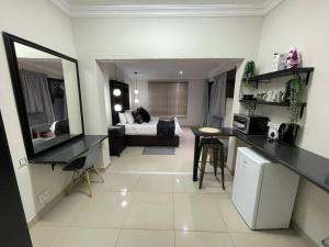 a kitchen and living room with a couch in a room at The Guesthouse Klerksdorp in Klerksdorp