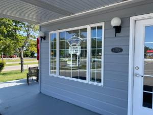 a front door of a house with a window at Lighthouse View Motel in Mackinaw City