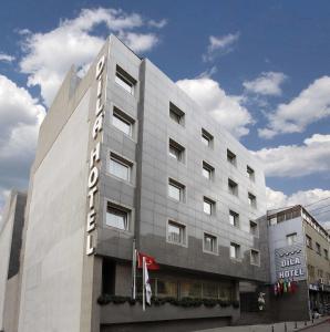 a building with a hotel sign on the side of it at Dila Hotel in Istanbul