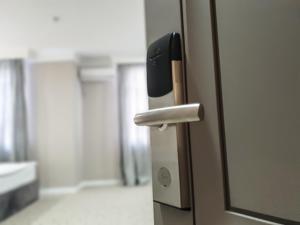 an open door in an office with a door handle at Ritz Hotel in Atyraū
