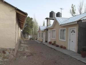 a row of buildings with a driveway between them at Tierras Blancas Nihuil in El Nihuil