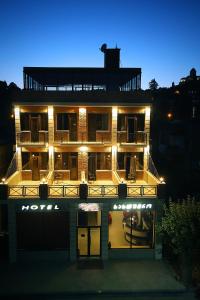 a large building with lights on it at night at Hotel Rero in Kutaisi