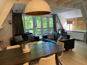 a living room with a table and a couch at Sunclass 206 in Durbuy