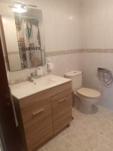 a bathroom with a sink and a toilet at Apartamento Playa de Coto in Barreiros