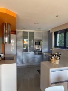 une cuisine avec des appareils en acier inoxydable et un comptoir dans l'établissement Casa en Sanxenxo con pisicina privada, à Sanxenxo