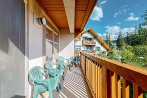 a balcony with blue chairs on the side of a building at Powderhorn Lodge 408: Rustic Mountain Suite in Solitude
