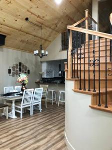 a dining room with a table and chairs and a staircase at Modern Cabin Get Away - close to APPLE HILL in Pollock Pines
