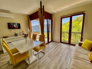 a living room with a white table and a couch at Adria Sea & Mountains in Herceg-Novi