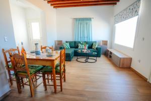 a living room with a table and a green couch at Villa Marmara in Cherronisos