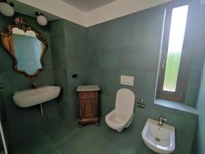 a bathroom with a sink toilet and a mirror at Cascina Flino - Tra le vigne - Appartamento 2 in Alba