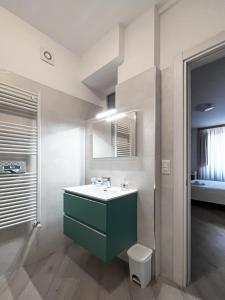 a bathroom with a green sink and a toilet at Residenza Sant'Angelo - Bike&Trekking House in Pietrapertosa