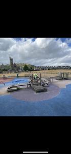 a group of picnic tables and benches on a beach at Burnt Island 2 bed apartment with stunning views in Fife