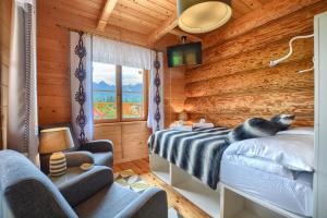 a log cabin bedroom with a bed and a window at Willa ANTONÓWKA in Kościelisko