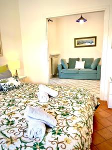 a bedroom with a bed with towels on it at Relais Serapo in Gaeta
