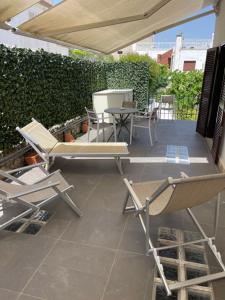 a patio with two chairs and a table and chairs at Relais Serapo in Gaeta