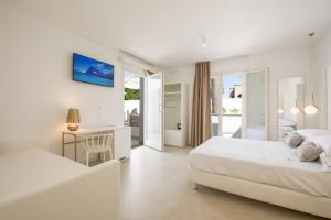 a white bedroom with two beds and a desk at Il Moro Camere&Relax in San Vito lo Capo +73 photos