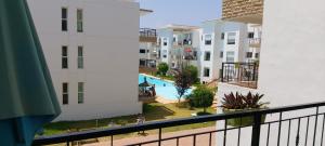 a view of a pool from a balcony of a apartment at Bouznika DREAMS in Bouznika +8 photos