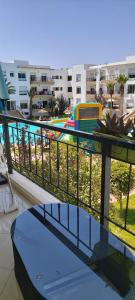 a balcony with a table and a view of a city at Bouznika DREAMS in Bouznika