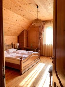 タターリウにあるMagnoliaの木製の部屋に大型ベッドが備わるベッドルーム1室が備わります。