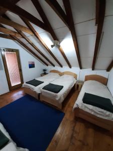 um quarto com 2 camas e um tapete azul em Vila Berbat em Ovcar Banja