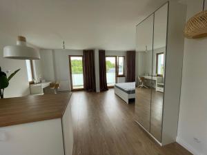 a large living room with a large mirror at cosy condo 5 min do plaży z balkonem Gdynia in Gdynia