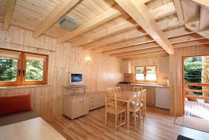 a kitchen and dining room with a table and chairs at Filarówka in Łeba