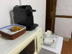 a basket of food sitting on top of a microwave at La Buhardilla de Torrecillas in El Bosque +15 photos