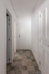 an empty hallway with a door and a tile floor at Mialon rural apartment: haven of calm in nature in La Esperanza