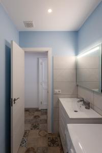 a bathroom with a white sink and a mirror at Mialon rural apartment: haven of calm in nature in La Esperanza