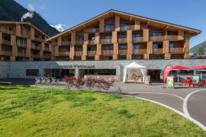 a red double decker bus parked in front of a building at Heliopic Hotel & Spa in Chamonix-Mont-Blanc