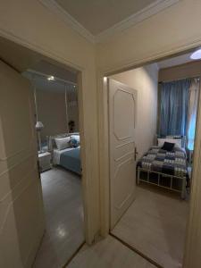 een kamer met een slaapkamer met een bed en een deur bij Eftihia di corfu in Corfu-stad