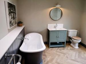 a bathroom with a sink and a toilet at Stunning New Forest Cottage close to Paultons Park in Ower