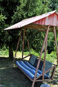 a porch swing with a roof on top of it at Vikendica za odmor Raduša in Tešanj