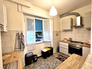 a kitchen with a stove and a window in it at Il giardino delle Cycas in Il Romito +15 photos