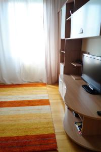 a living room with a television and a large window at Appartamento Mirandola in Mirandola