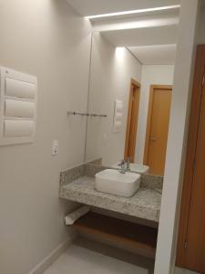 a bathroom with a sink and a mirror at Salinas Exclusive Resort in Salinópolis