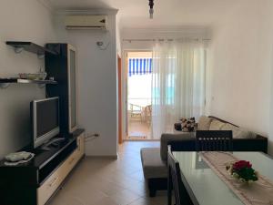 a living room with a couch and a television at Isabel in Durrës