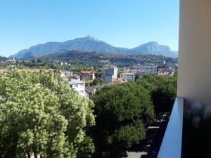 a view of a city with mountains in the background at Gambetta Insolite in Chambéry