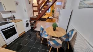 a kitchen and dining room with a table and chairs at Cheerful 2 Bedroom home in Stoke on Trent in Stoke on Trent