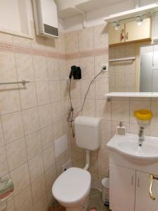 a bathroom with a toilet and a sink at STUDIO APARTMAN Marita in Split