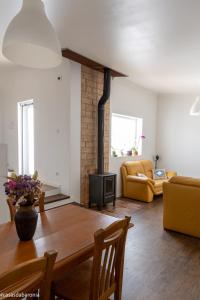 a living room with a table and a couch at Casas da Baronia in Vila Nova da Baronia