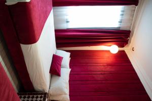 a small room with a bed and a window at Hotel Majestic in Casablanca