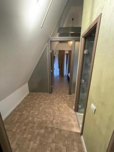 an empty hallway with a staircase with a floor of tiles at Green Property in Dofteana
