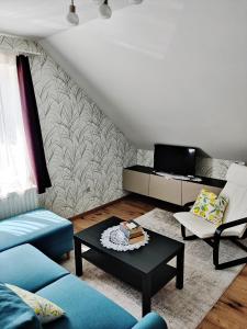 a living room with a couch and a coffee table at FaDóra Apartman in Tihany