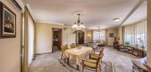 a dining room with a table and chairs at Fortuna Villa in Hévíz