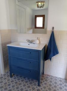 a bathroom with a blue sink and a mirror at Amplia y cómoda casa de piedra con porche y jardín in San Roque de Ríomiera